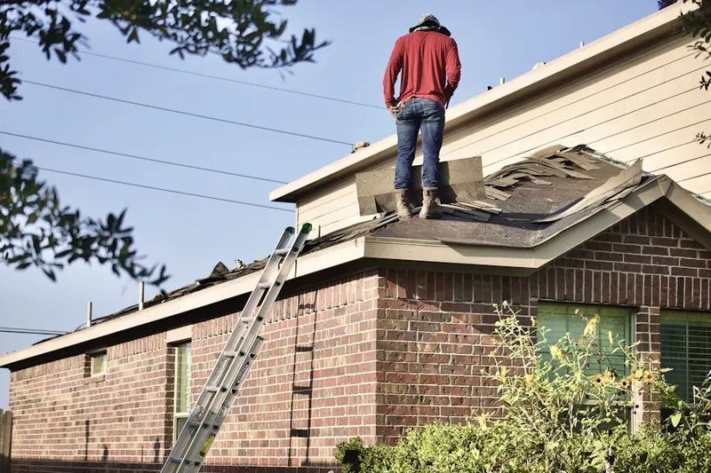 Professional roofer working on a residential roof in South Utica